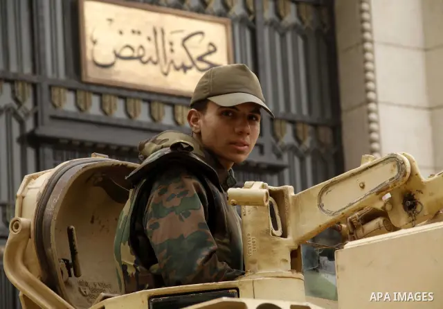 Egyptian soldiers stands guard as protesters take part in a rally calling for release of political prisoners in Cairo, Egypt, Wednesday, Feb. 16, 2011. Photo by Ahmed Asad