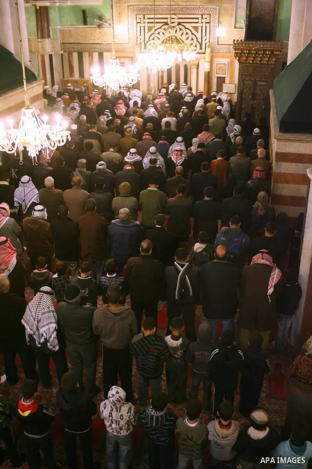 Palestinians take part in Ibrahimi mosque as they march in a procession to mark the birth anniversary of Islam's prophet Mohammed, in the West Bank city of Hebron Tuesday, Feb. 16, 2011. Muslims celebrate Prophet Mohamme...