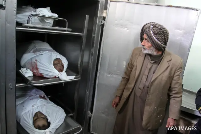 A Palestinian man looks at the bodies of the three killed Palestinians, at the morgue in Kamal Adwan hospital in the town of Beit Lahiya, northern Gaza Strip, on Feb. 17, 2011. Three Palestinian fishermen were slain on e...