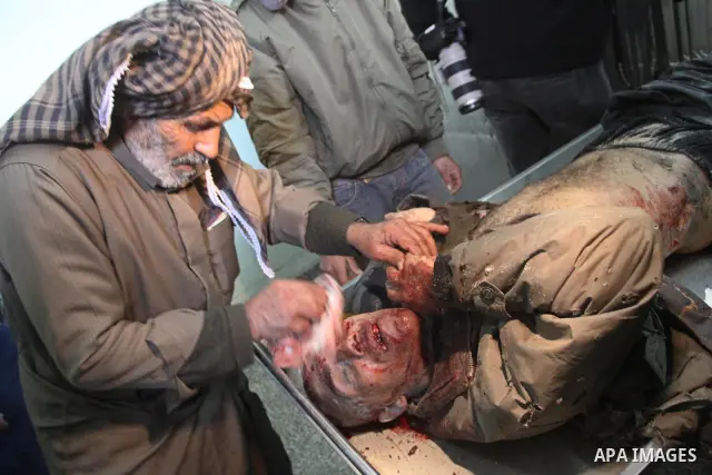 A Palestinian man cleans the body of one of the three killed Palestinians, at the morgue in Kamal Adwan hospital in the town of Beit Lahiya, northern Gaza Strip, on Feb. 17, 2011. Three Palestinian fishermen were slain o...
