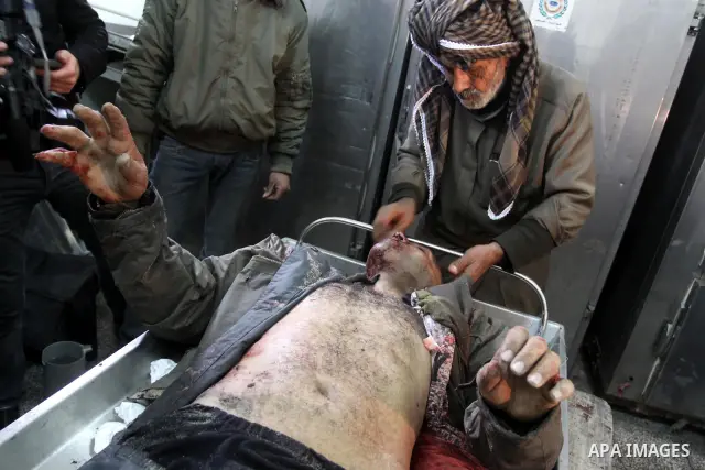 A Palestinian man cleans the body of one of the three killed Palestinians, at the morgue in Kamal Adwan hospital in the town of Beit Lahiya, northern Gaza Strip, on Feb. 17, 2011. Three Palestinian fishermen were slain o...