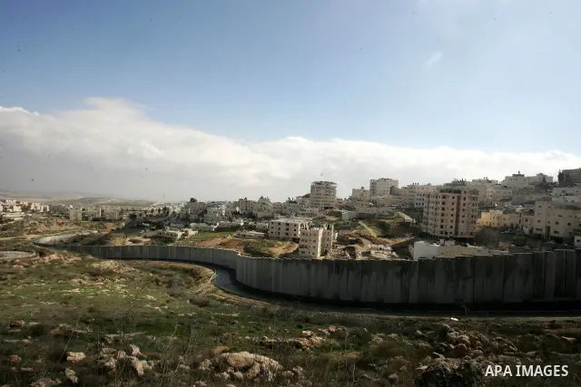 A view of the controversial Israeli separation barrier on the outskirts of Jerusalem on February 17,2011. On the top the Israeli settlement of Pisgat Zeev and on the bottom the refugee camp of Shuafat . Photo by Mahfouz...