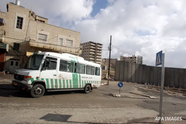A bus is seen in a street of the refugee camp of Shuafat on the outskirts of Jerusalem on February 17,2011. Photo by Mahfouz Abu Turk