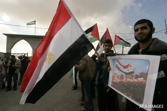 Palestinian youths take part in a march to show support for the Egyptian protesters in Egypt who forced their President Hosni Mubarak to resign, in front of the Rafah border crossing, southern Gaza Strip with Egypt on Fe...