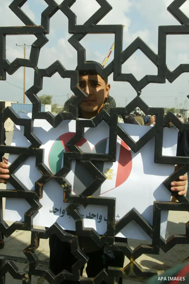 A Palestinian youth takes part in a march to show support for the Egyptian protesters in Egypt who forced their President Hosni Mubarak to resign, in front of the Rafah border crossing, southern Gaza Strip with Egypt on...