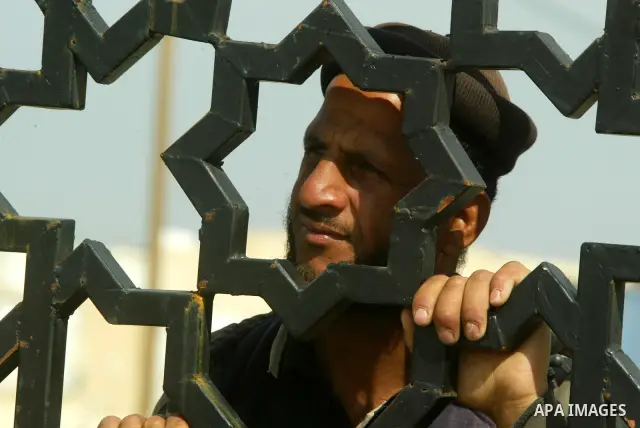 A Palestinian man takes part in a march to show support for the Egyptian protesters in Egypt who forced their President Hosni Mubarak to resign, in front of the Rafah border crossing, southern Gaza Strip with Egypt on Fe...
