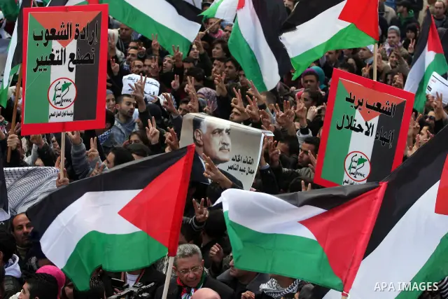 Palestinians take part in a rally calling for ending the Palestinian division, in the West Bank city of Ramallah on Feb. 17, 2011. More than 3000 protesters call for free elections and the reconciliation between the two...