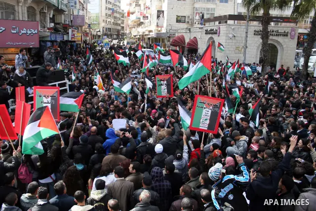 Palestinians take part in a rally calling for ending the Palestinian division, in the West Bank city of Ramallah on Feb. 17, 2011. More than 3000 protesters call for free elections and the reconciliation between the two...