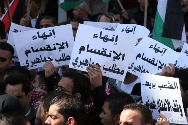 Palestinians take part in a rally calling for ending the Palestinian division, in the West Bank city of Ramallah on Feb. 17, 2011. More than 3000 protesters call for free elections and the reconciliation between the two...