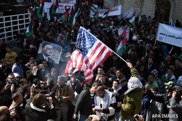 Palestinians take part in a rally calling for ending the Palestinian division, in the West Bank city of Ramallah on Feb. 17, 2011. More than 3000 protesters call for free elections and the reconciliation between the two...