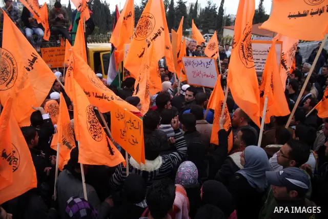 Palestinian National Initiative supporters take part in a demonstration to demand the adoption of "Law of the National Fund for Higher Education" in front of the prime minister building in the West Bank city of Ramallah...