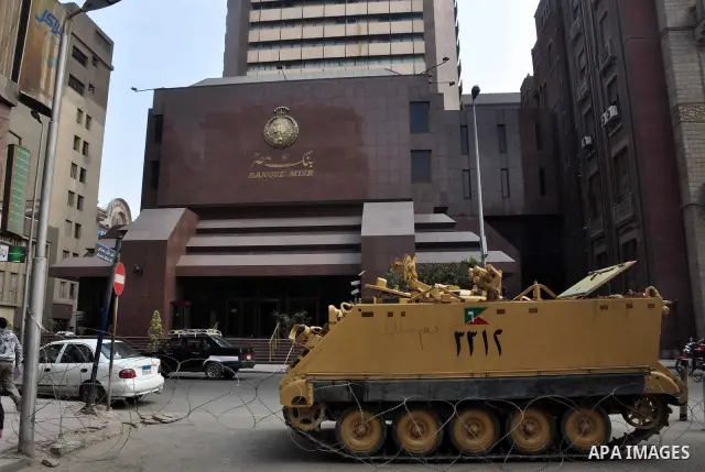 Armored vehicles are seen in front of an Egyptian bank in Cairo, Egypt on Feb 17,2011. Mubarak's departure set off a chain reaction around the Middle East, with anti-government demonstrations reported Wednesday in Libya,...