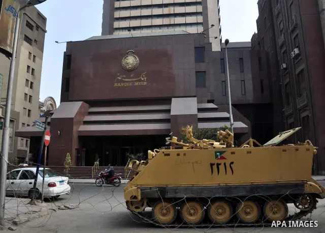 Armored vehicles are seen in front of an Egyptian bank in Cairo, Egypt on Feb 17,2011. Mubarak's departure set off a chain reaction around the Middle East, with anti-government demonstrations reported Wednesday in Libya,...