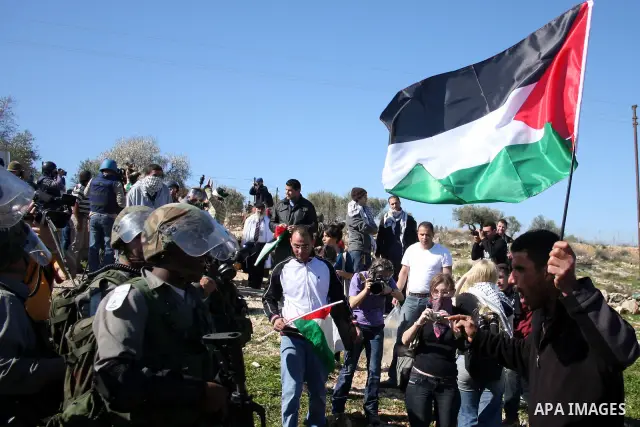 Israeli soldiers scuffle with Palestinian protesters during the weekly demonstration against Israel's separation barrier in the West Bank village of Bilin near Ramallah, Friday, Feb. 18, 2011. Photo by Issam Rimawi