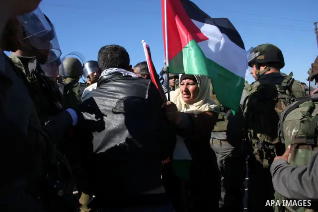 Israeli soldiers scuffle with Palestinian protesters during the weekly demonstration against Israel's separation barrier in the West Bank village of Bilin near Ramallah, Friday, Feb. 18, 2011. Photo by Issam Rimawi