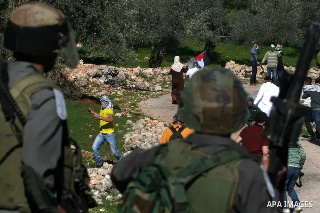 Israeli soldiers scuffle with Palestinian protesters during the weekly demonstration against Israel's separation barrier in the West Bank village of Bilin near Ramallah, Friday, Feb. 18, 2011. Photo by Issam Rimawi