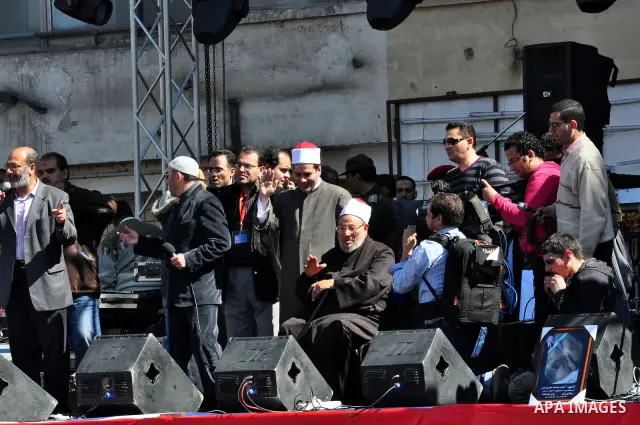 Egyptian cleric Sheik Youssef el-Qaradawi leads Friday prayers in Tahrir Square in Cairo, Egypt, Friday Feb. 18, 2011. Tens of thousands of flag-waving Egyptians packed into Tahrir Square for a day of prayer and celebrat...