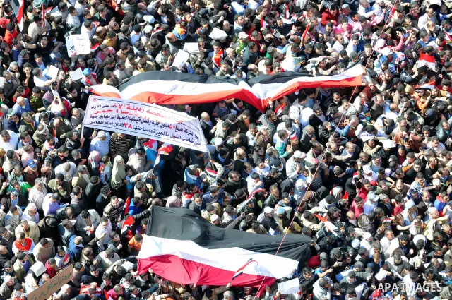 An Egyptian woman attends a march at Tahrir Square in Cairo, Egypt, Feb. 18, 2011. Tens of thousands of flag-waving Egyptians packed into Tahrir Square for a day of prayer and celebration Friday to mark the fall of Hosni...