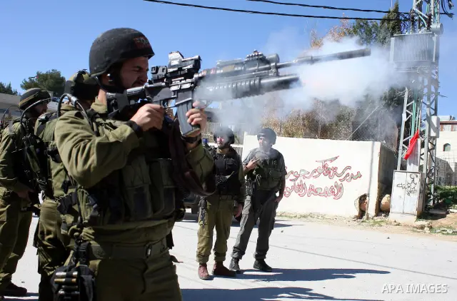 Israeli soldiers fire tear gas canisters towards Palestinian ,Israeli and International protesters during a demonstration against Israel's controversial separation barrier in the West Bank village of Maasarah, near the b...
