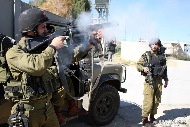 Israeli soldiers fire tear gas canisters towards Palestinian ,Israeli and International protesters during a demonstration against Israel's controversial separation barrier in the West Bank village of Maasarah, near the b...