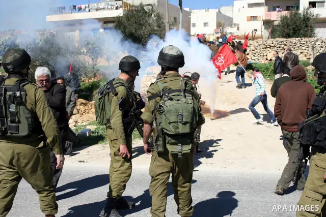 Israeli soldiers fire tear gas canisters towards Palestinian ,Israeli and International protesters during a demonstration against Israel's controversial separation barrier in the West Bank village of Maasarah, near the b...