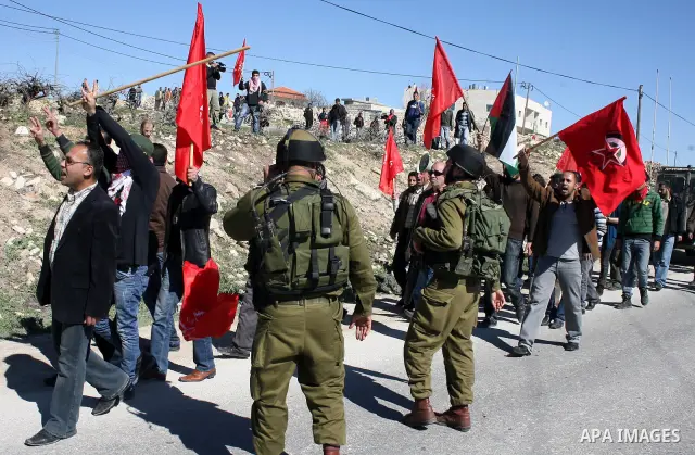 Israeli soldiers argue with Palestinian, Israeli and International protesters during a demonstration against Israel's controversial separation barrier in the West Bank village of Maasarah, near the biblical town of Bethl...