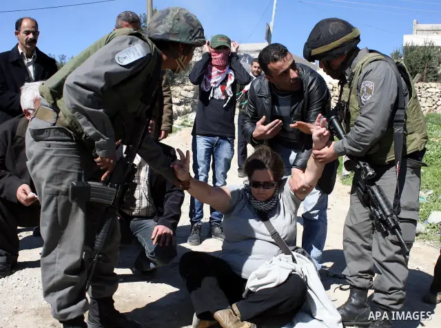 Israeli soldiers argue with Palestinian, Israeli and International protesters during a demonstration against Israel's controversial separation barrier in the West Bank village of Maasarah, near the biblical town of Bethl...