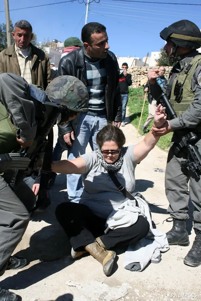 Israeli soldiers argue with Palestinian, Israeli and International protesters during a demonstration against Israel's controversial separation barrier in the West Bank village of Maasarah, near the biblical town of Bethl...