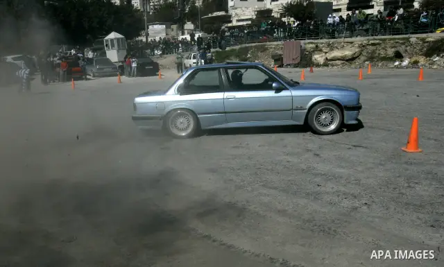 A Palestinian driver takes part in car race in the West Bank city of Nablus, Friday, Feb, 18, 2011. Photo by Wagdi Eshtayah