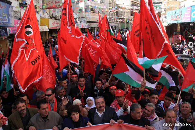 Palestinians take part during a demonstration calling to end the split between the West Bank and Gaza, marking the 42th anniversary of the Democratic Front for the Liberation of Palestine (DFLP) in the West Bank city of...