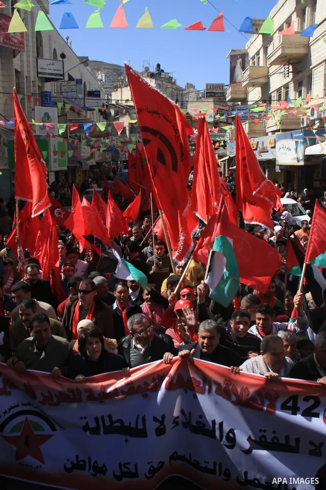 Palestinians take part during a demonstration calling to end the split between the West Bank and Gaza, marking the 42th anniversary of the Democratic Front for the Liberation of Palestine (DFLP) in the West Bank city of...