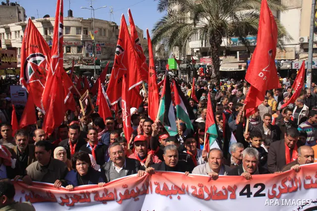 Palestinians take part during a demonstration calling to end the split between the West Bank and Gaza, marking the 42th anniversary of the Democratic Front for the Liberation of Palestine (DFLP) in the West Bank city of...