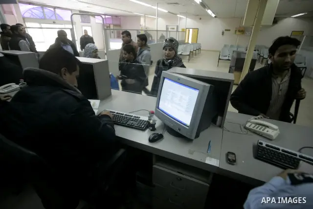 Hamas security officials check the travel documents of Palestinians upon their arrival to the Gaza Strip from the Rafah border terminal between Egypt and the coastal strip on February 19, 2011. The Egyptian authorities r...