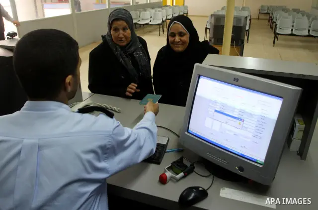 Hamas security officials check the travel documents of Palestinians upon their arrival to the Gaza Strip from the Rafah border terminal between Egypt and the coastal strip on February 19, 2011. Egypt reopened its Rafah b...