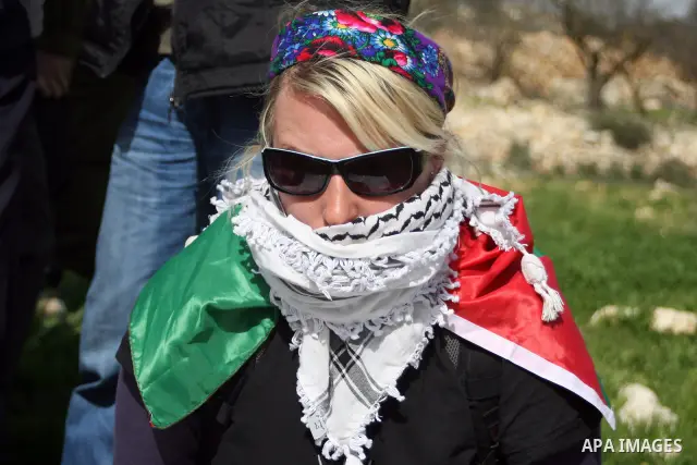 Palestinian, Israeli and foreign activists take part in a demonstration against the demolishing of farm land to be used in the construction of Jewish settlements near the existing Israeli settlement of Karmi Tsor near th...