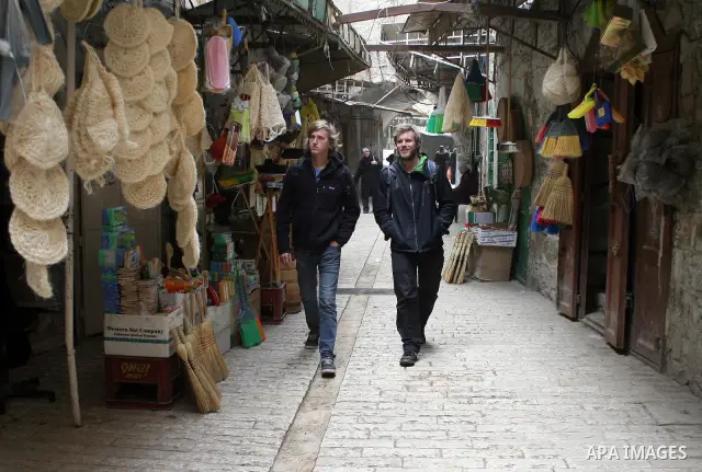 Foreigners shop in a traditional market at the old city in the West Bank city of Hebron on February 20, 2011. Photo by Najeh Hashlamoun