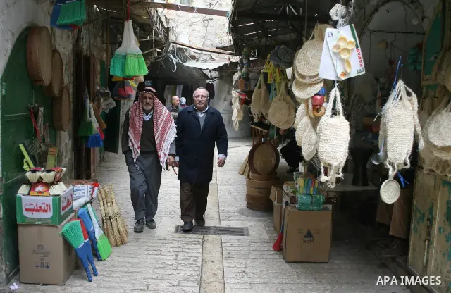 Palestinians shop in a traditional market at the old city in the West Bank city of Hebron on February 20, 2011. Photo by Najeh Hashlamoun .