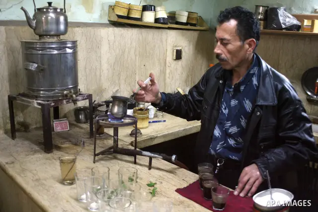 Palestinians sit in a coffee shop in a traditional market at the old city in the West Bank city of Hebron on February 20, 2011. Photo by Najeh Hashlamoun