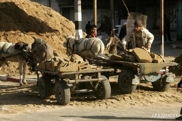 Palestinian children extract the stone from the sand, To re-manufacture a new block in the Rafah refugee camp southern Gaza Strip on February 21, 2011. Because of the Israeli siege and closure of the crossings and preven...