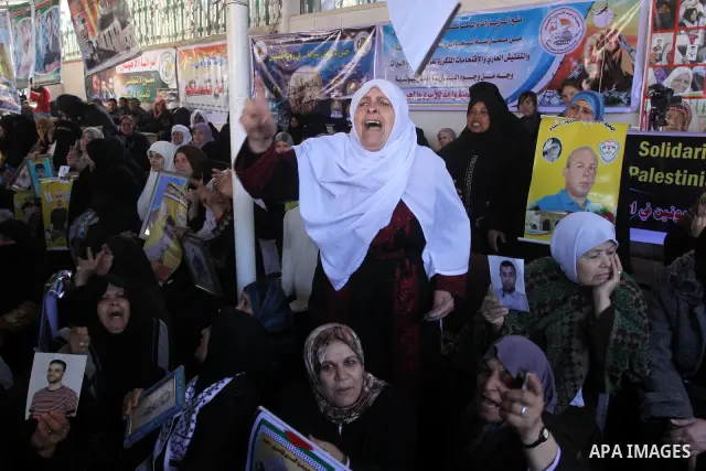 Palestinian women hold pictures of jailed relatives during a protest calling for the release of Palestinian prisoners from Israeli jails at the Red Cross office in Gaza City on Feb. 21, 2011. Photo by Mohammed Asad