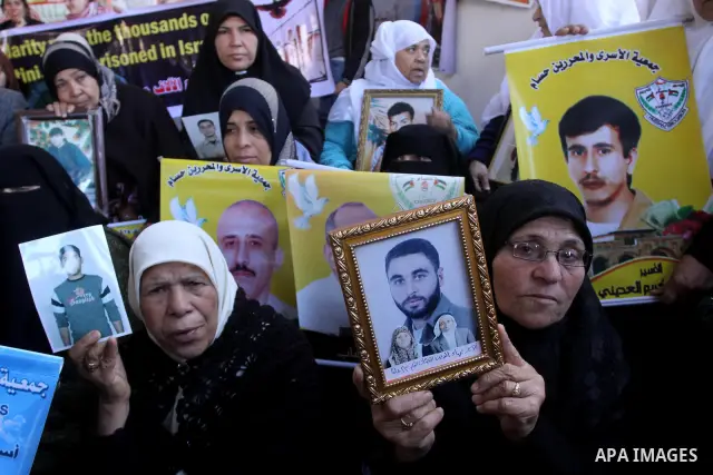 Palestinian women hold pictures of jailed relatives during a protest calling for the release of Palestinian prisoners from Israeli jails at the Red Cross office in Gaza City on Feb. 21, 2011. Photo by Mohammed Asad