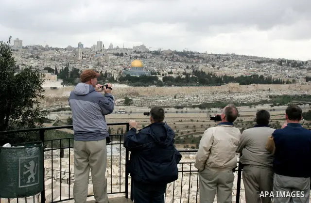 Foreign tourists take picture for the Dome of the Rock at the Al-Aqsa Mosque compound in Jerusalem on Feb. 21,2011. Photo by Mahfouz Abu Turk