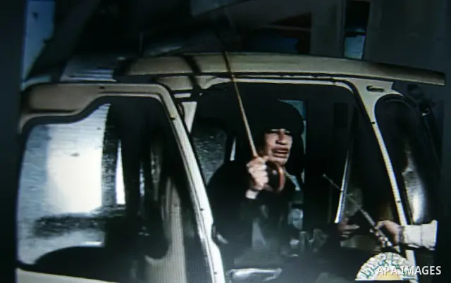 In this image taken from Libyan Television "Jamahiriya" shows Libyan leader Moammar Gadhafi, early Tuesday on Feb. 22, 2011. Gadhafi appeared for less than a minute on state television and made brief remarks to say he wa...
