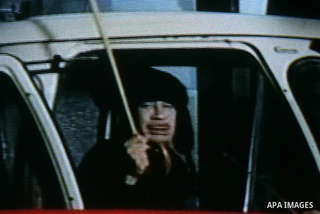 In this image taken fromAl Jazeera television, shows Libyan leader Moammar Gadhafi, early Tuesday on Feb. 22, 2011. Gadhafi appeared for less than a minute on state television and made brief remarks to say he was in the...
