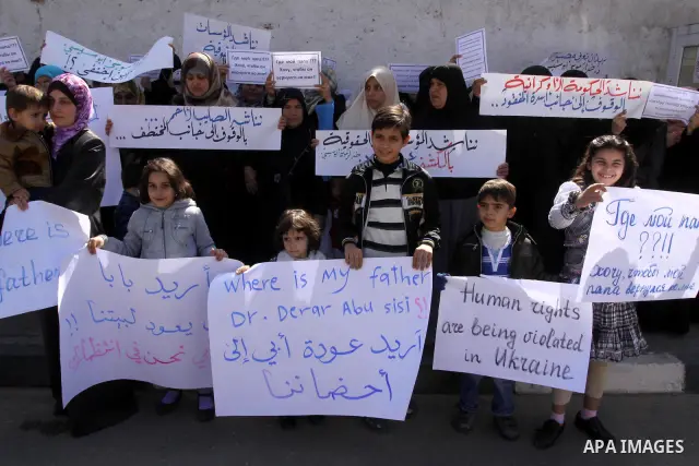 Palestinians demonstrate during a protest to show solidarity with Derar Abu Sissi family, who was kidnapped by an unidentified people in Ukraine, in front of Red Cross building, Gaza City on Feb. 22, 2011. Photo by Moham...