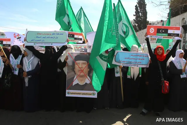 Palestinian students hold up placards during a protest against Libyan leader Moamer Kadhafi, in Gaza City on February 22, 2011. Gaza's Hamas rulers heaped condemnation on "the massacres" of anti-government protestors in...