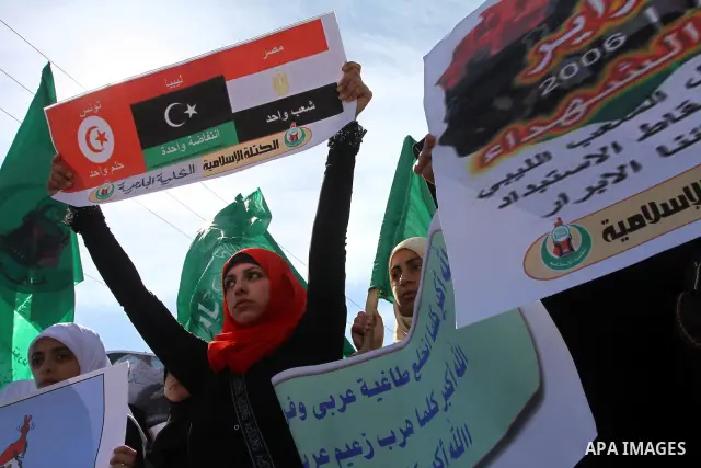 Palestinian students hold up placards during a protest against Libyan leader Moamer Kadhafi, in Gaza City on February 22, 2011. Gaza's Hamas rulers heaped condemnation on "the massacres" of anti-government protestors in...