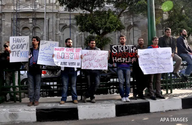 Protesters take part in a protest against Libyan Leader Moammar Gadhafi in front of the Arab league in Cairo, Egypt, Feb. 22, 2011. Protesters gathered at the protest against Gadhafi's crackdown on peaceful protesters in...