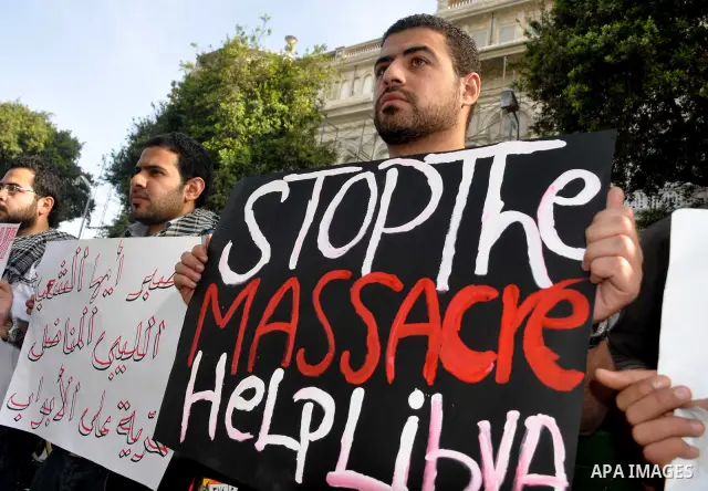 Protesters take part in a protest against Libyan Leader Moammar Gadhafi in front of the Arab league in Cairo, Egypt, Feb. 22, 2011. Protesters gathered at the protest against Gadhafi's crackdown on peaceful protesters in...