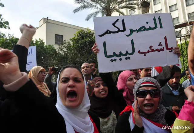Protesters take part in a protest against Libyan Leader Moammar Gadhafi in front of the Arab league in Cairo, Egypt, Feb. 22, 2011. Protesters gathered at the protest against Gadhafi's crackdown on peaceful protesters in...
